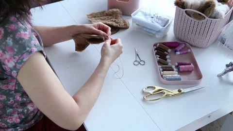 Women's hands create a textile product, toy, pattern Stock Footage 88227283
