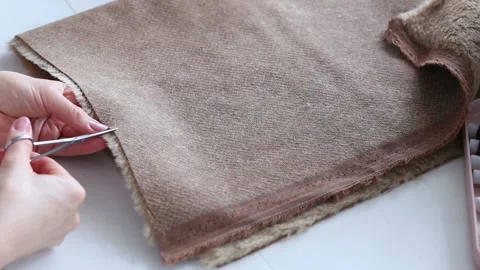 Women's hands create a textile product, toy, pattern Stock Footage 88228522