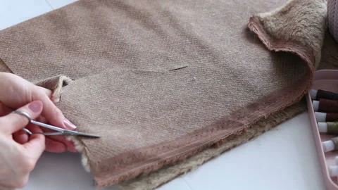 Women's hands create a textile product, toy, pattern Stock Footage 88229302