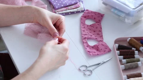 Women's hands create a textile product, toy, pattern Stock Footage 88230020