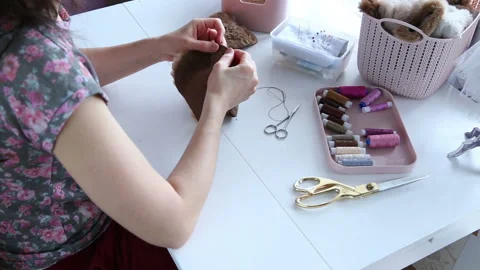 Women's hands create a textile product, toy, pattern Video stock 88239826