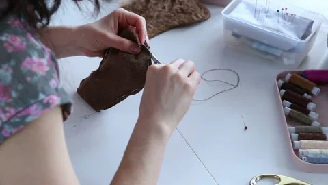 Women's hands create a textile product, toy, pattern Video stock 88245493
