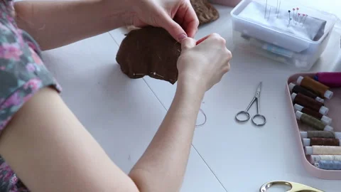 Women's hands create a textile product, toy, pattern Video stock 88245526