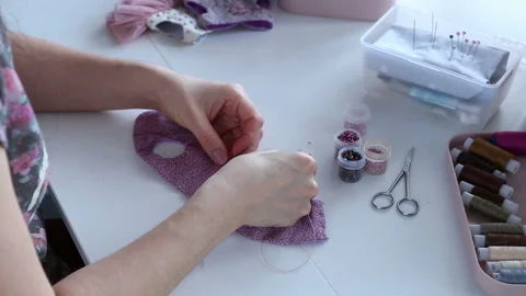 Women's hands create a textile product, toy, pattern Video stock 88245600