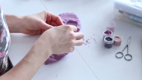 Women's hands create a textile product, toy, pattern Video stock 88245619
