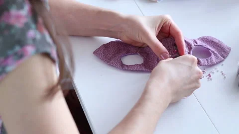 Women's hands create a textile product, toy, pattern Video stock 88245654