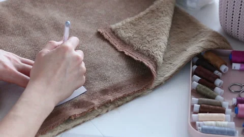 Women's hands create a textile product, toy, pattern Video stock 88245748