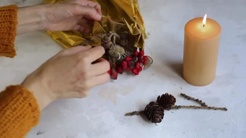Women's hands creating a Christmas composition from natural materials. The idea Stock Footage 220434530