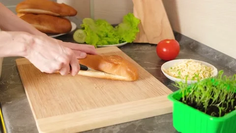 Women's hands cut bread for making sandwiches Video stock 152093240