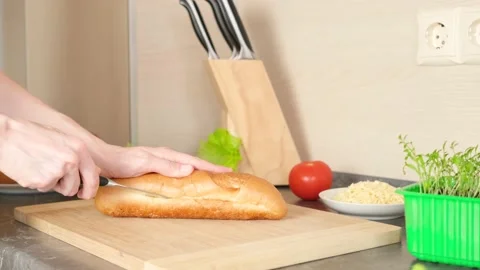 Women's hands cut bread for making sandwiches Stock Footage 152093846