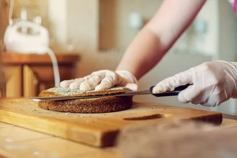 Women's hands cut the cake of the future cake Stock Photos
