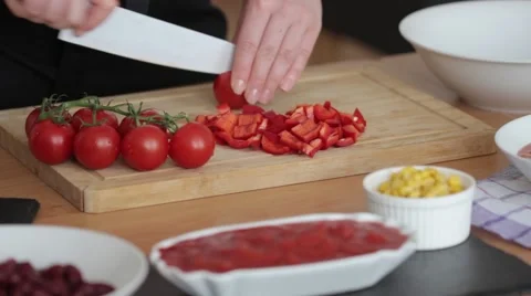 Women's hands cut cherry tomatoes Stock Footage 67105200