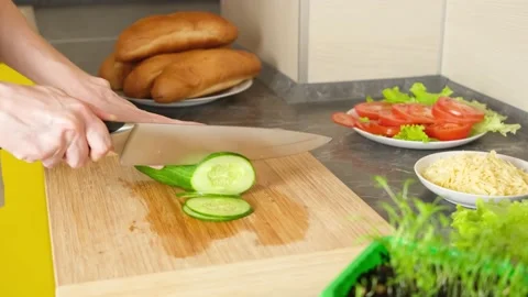 Women's hands cut cucumber for making sandwiches Stock Footage 152093632
