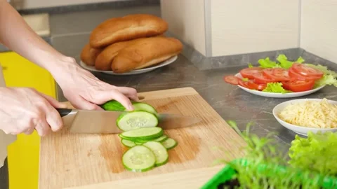 Women's hands cut cucumber for making sandwiches Stock Footage 152093911