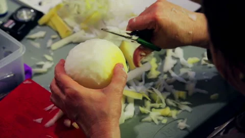 Women's hands cut with scissors the foam for toys giving it a round shape. 库存影片 108271389