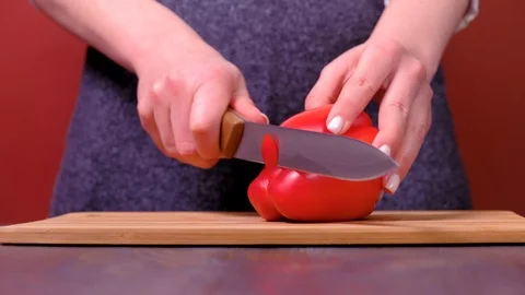 Women's hands cut vegetables on table Stock Footage 123338195