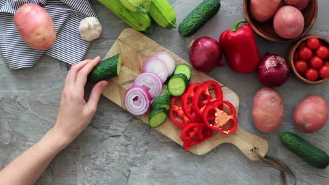 Women's hands cutting vegetables on the kitchen table. Cooking for vegetarian Stock Footage 131568978