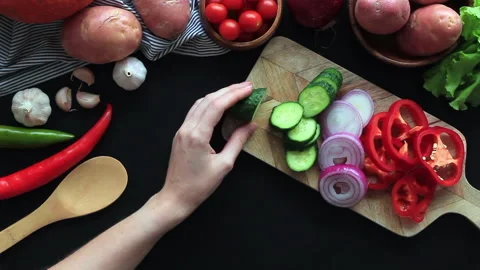 Women's hands cutting vegetables on the kitchen table. Cooking for vegetarian Stock Footage 133203607