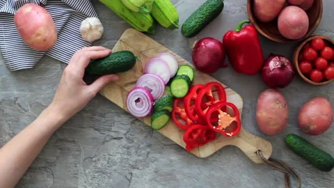 Women's hands cutting vegetables on the kitchen table. Cooking for vegetarian Stock Footage 133205242