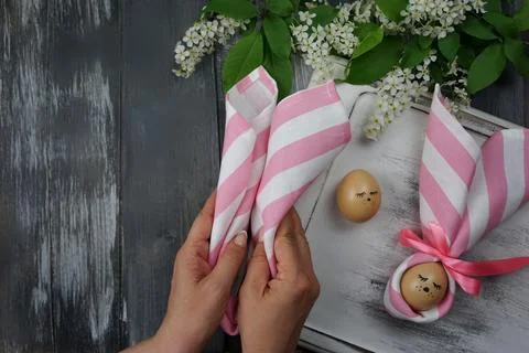 Women's hands decorate Easter eggs Stock Photos