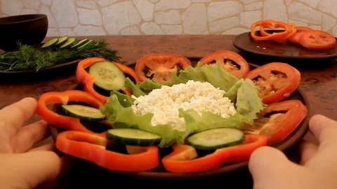 Women's hands decorate a vegetable salad Stock Footage 86988085
