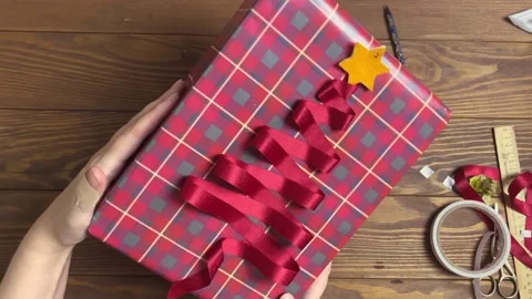 Women's hands demonstrate gift box with original design. Video stock 198671943