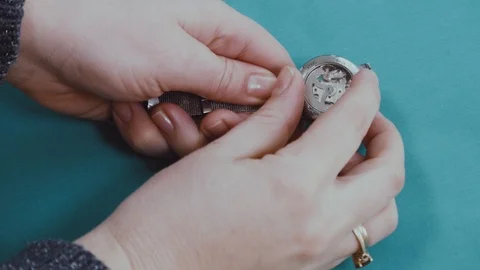 Women's hands dismantle the clock Stock Footage 102306219