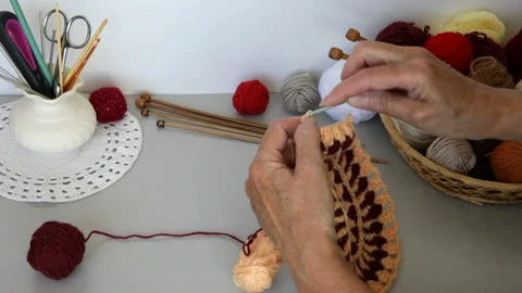 Women's hands do needlework and crochet lace round doily from wool yarn Stock Footage 201730787
