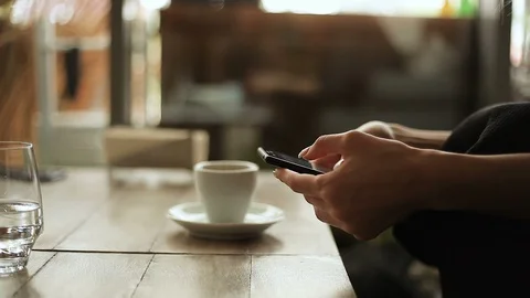 Women's hands flipping through the Internet, next to a Cup of coffee Stock Footage 111780201