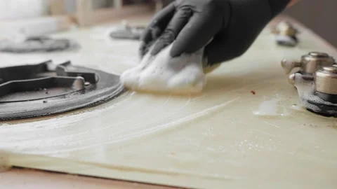 Women's hands in gloves rub a sponge cooking surface with foam Video stock 151920123