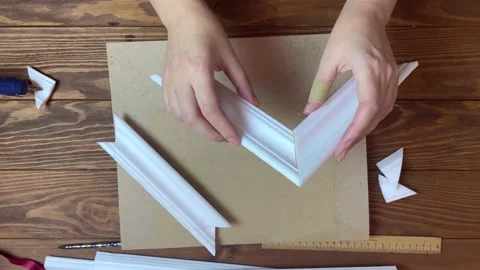 Women's hands gluing details of frames made of moldings. Stock Footage 156514197