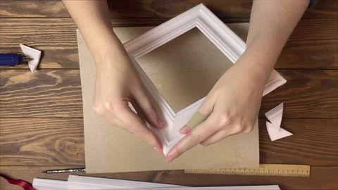 Women's hands gluing frames made of styrofoam. Stock Footage 155005196