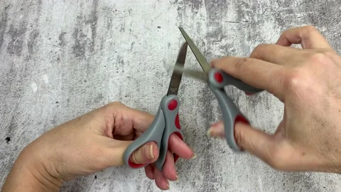 Women's hands hold scissors and cut each other Stock Footage 231880828