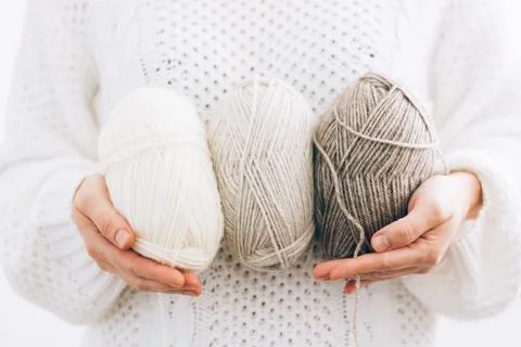 Women's hands hold threads for knitting, made of natural environmentally Stock Photos