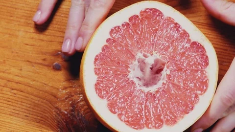 Women's hands holding a grapefruit, close-up Stock Footage 103461602