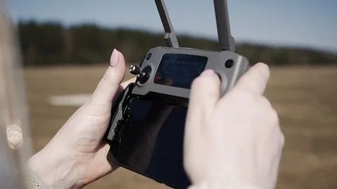 Women's hands holding a remote control drone Stock Footage 106718207