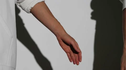 Women's hands join in a handshake,close-up,white background Stock Footage 199250986