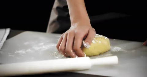 Women's hands knead the dough for shortbread cookies on a silicone mat. Stock Footage 181383007