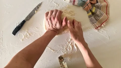 Women's hands Kneading Bread Dough on Floured Surface Top View Baking Scene Stock Footage 307498982