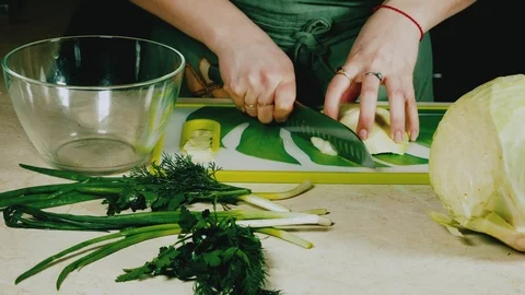 Women's hands with a knife cuts cabbage. Stock Footage 103954166