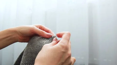 Women's hands knit from grey wool at home Stock Footage 142906111