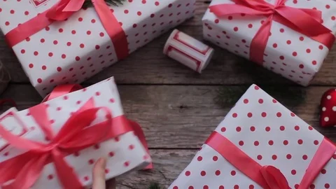 Women's Hands Lay Down a Holiday Gift Boxes on a Wooden Table Stock Footage 71508275