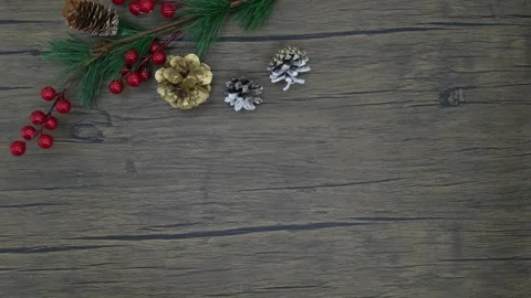 Women's hands lay out pine cones and a fir branch on a wooden table Stock Footage 312282601