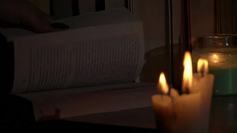 Women's Hands Leaf Through an Old Book By Candlelight Stock Footage 229543960
