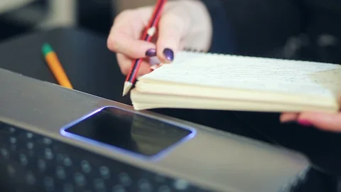 Women's hands make a record in a paper notebook Stock Footage 102153415