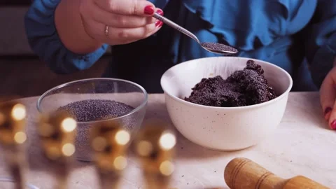 Women's hands make the stuffing for gomentashi cookies from prunes and poppy Stock Footage 171466168