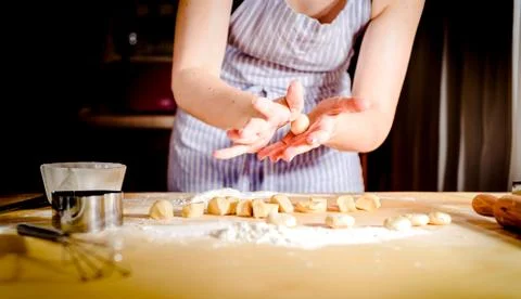 Women's hands making the dough, selective focus Stock Photos