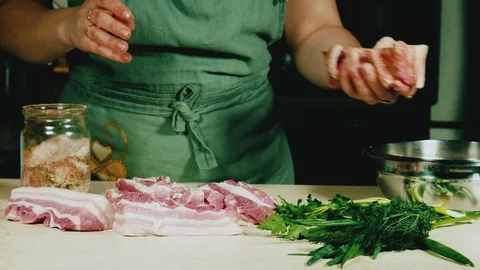 Women's hands marinate raw bacon with salt and spices Stock Footage 103954084