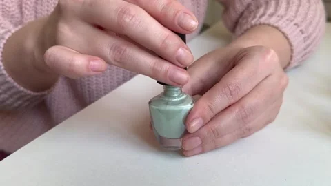 Women's hands open a bottle of nail polish close-up, manicure Stock Footage 255037833