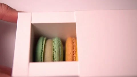 Women's hands open box of macaroon cookies. Stock Footage 159769041